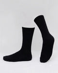 A pair of black ribbed crew socks displayed on invisible forms against a clean white studio background.